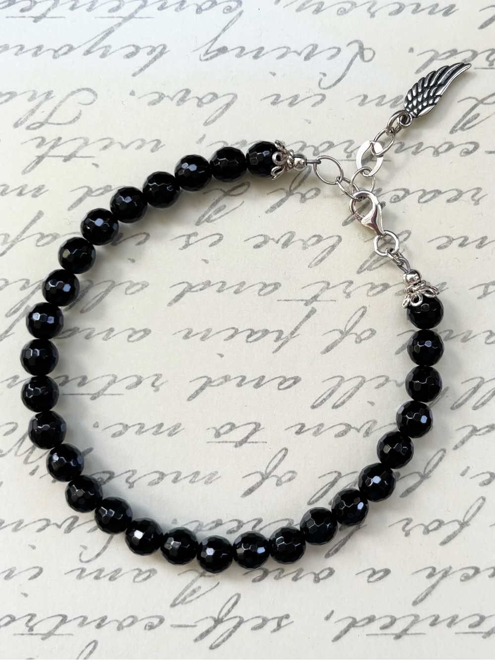 Sterling Silver Black Onyx Faceted Bead Bracelet with Wing Charm